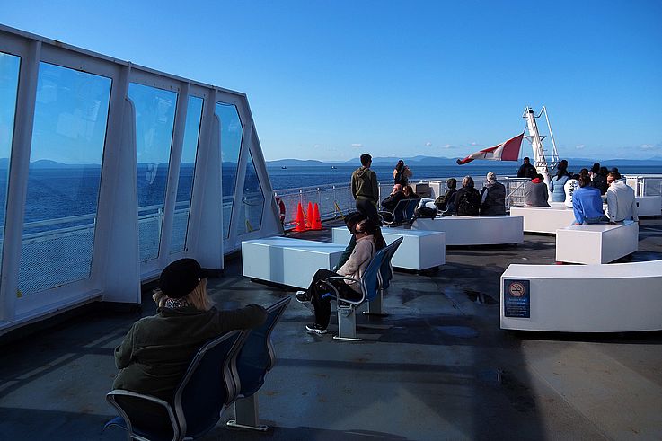 Passengers on the outer deck of a BC Ferries vessel in the Strait of Georgia.