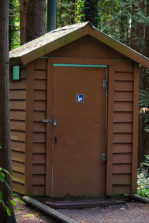 Dry toilet cabin in a forest campground.