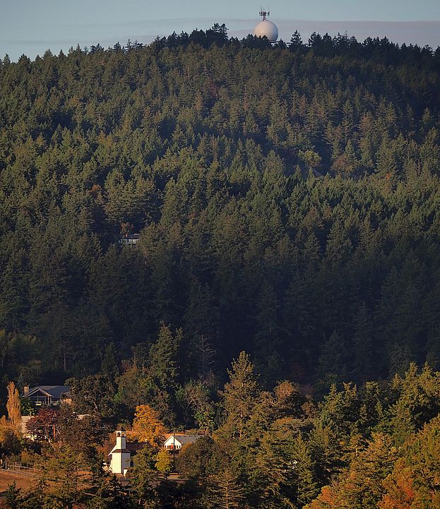 Radome on Willis Point overlooking the church and the forest in autumn.