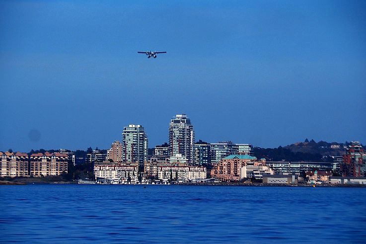 Seaplane over the Nanaimo waterfront and its urban skyline.