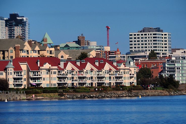Waterfront residences and Victoria skyline along James Bay.