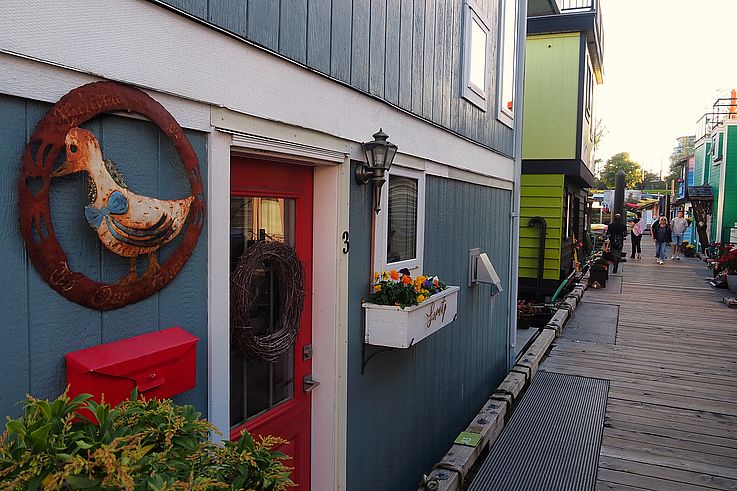 Colorful floating houses along Fisherman's Wharf in Victoria.