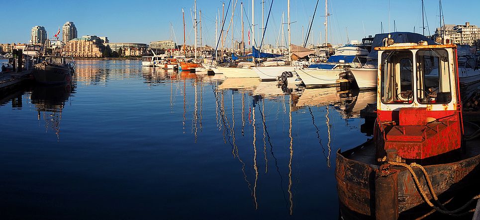 Sailboats and reflections on the water at Fisherman's Wharf in Victoria.