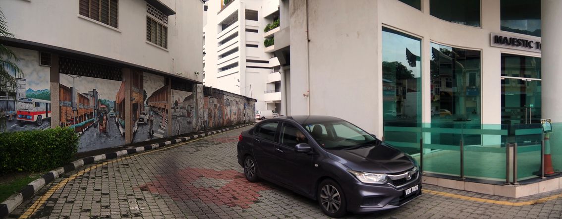 Street art mural and The Majestic Tower in Ipoh.