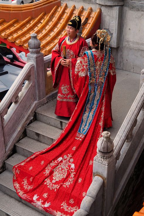 Couple in traditional wedding attire at Kek Lok Si Temple, George Town, Paya Terubong.