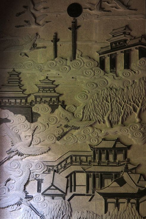 Stone relief of Kek Lok Si Temple in George Town, featuring Nantianmen Gate and cranes.