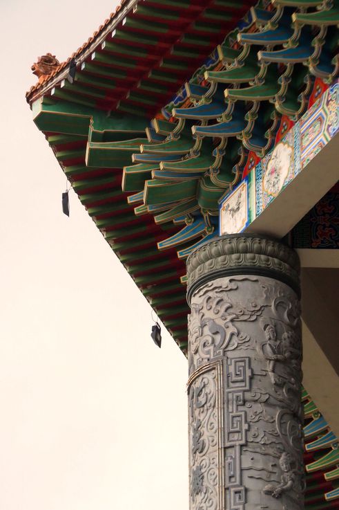 Carved pillar and roof detail with dragon sculpture at Kek Lok Si Temple.
