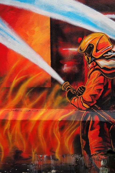 Mural "Beacon of Hope" in George Town, firefighter figure.