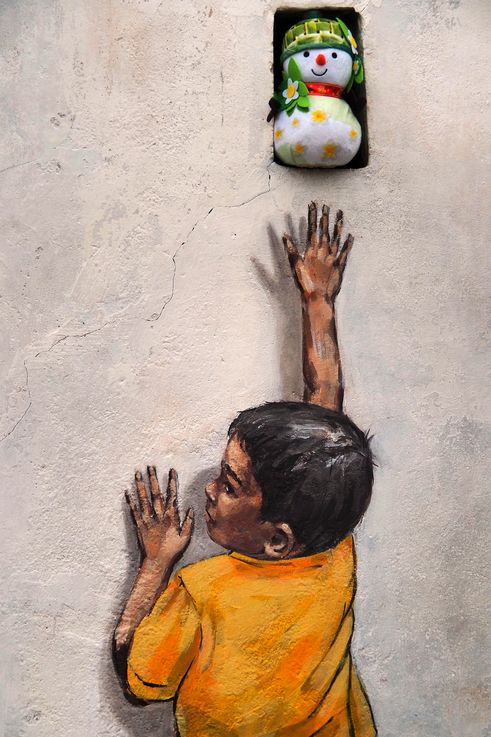 Street art "Boy with Snowman" by Ernest Zacharevic in George Town.