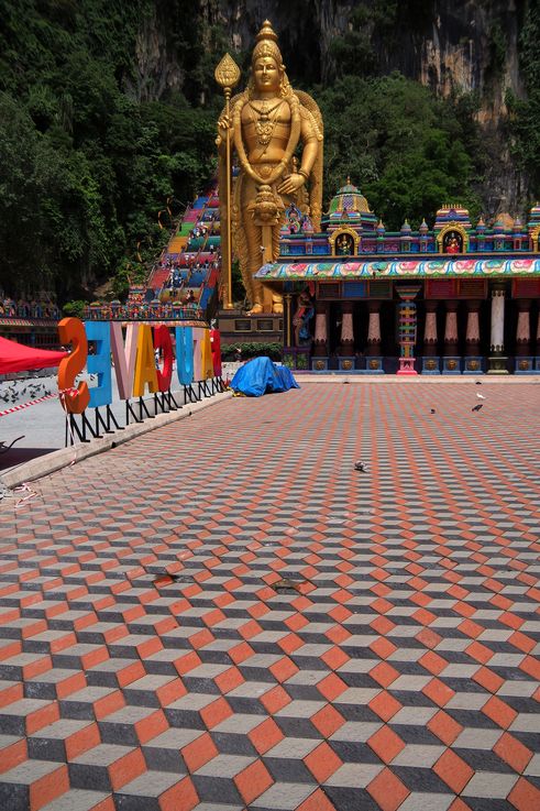 Statue of Lord Murugan from Batu Caves temple, with its polychrome staircase.