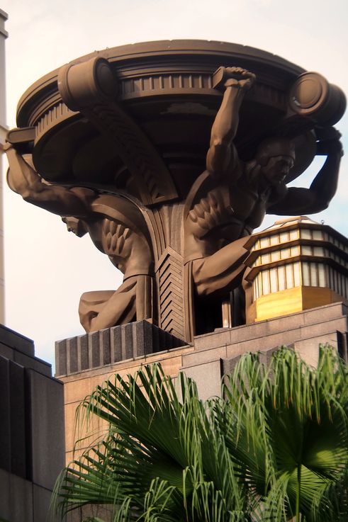 Atlantes adorning the facade of the Raffles Hotel.